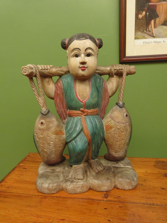 Vintage Asian wooden figure carrying fish