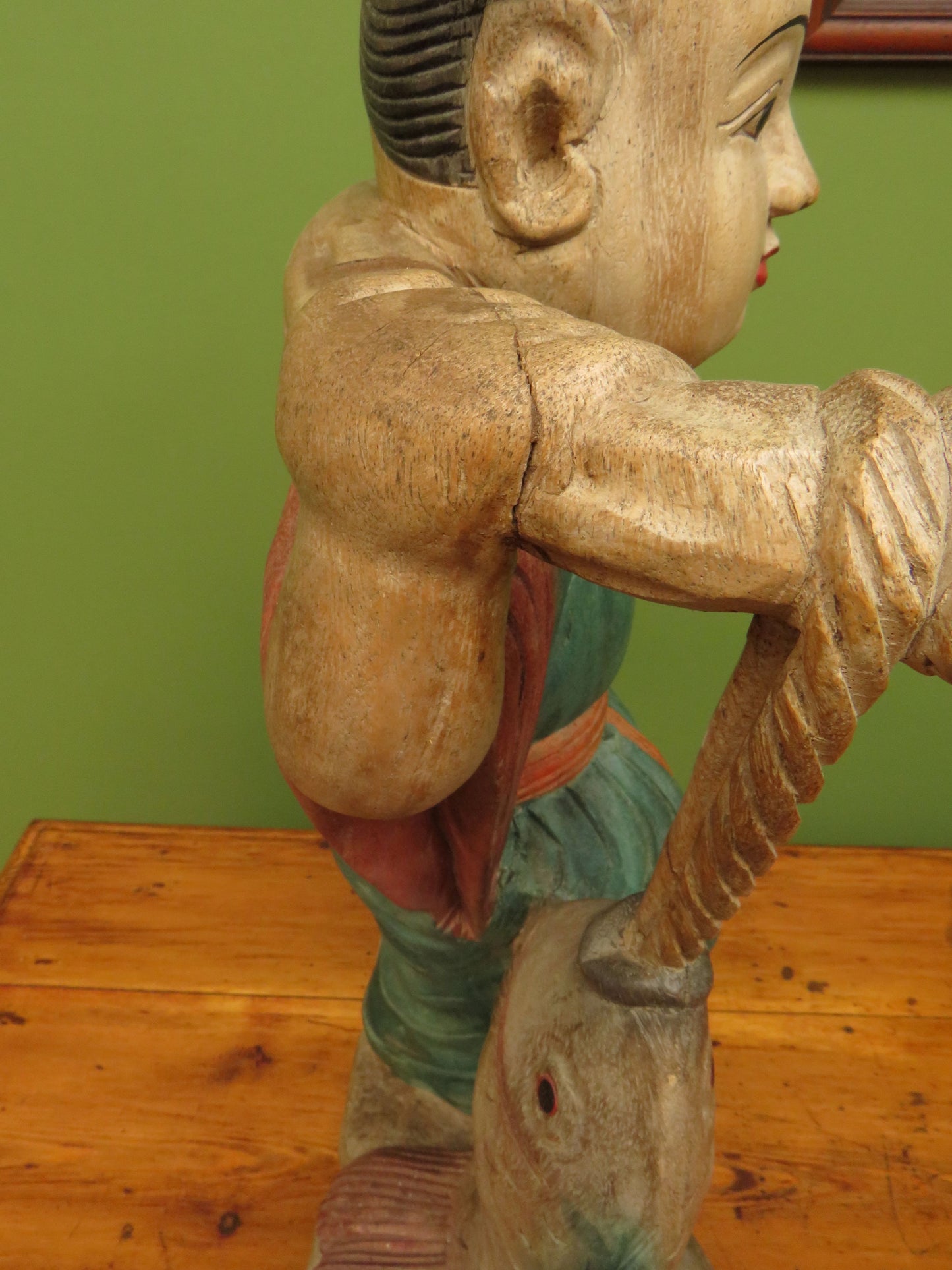 Vintage Asian wooden figure carrying fish